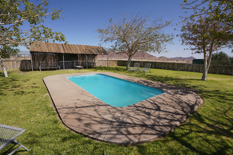 Beautiful pool in green garden at Little Sossus Camping Sesriem